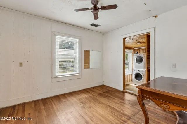 a view of an entryway and wooden floor