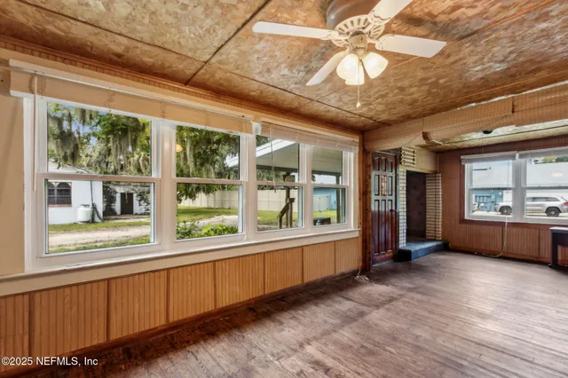 a large room with a large window and furniture