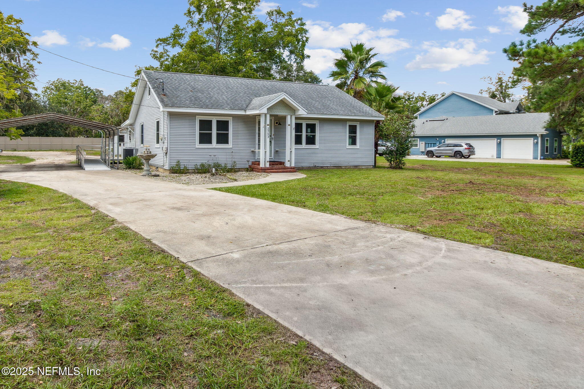2753 Amelia Road Fernandina Beach, FL 32034 - Photo 40 of 40 a front view of a house with a yard and garage