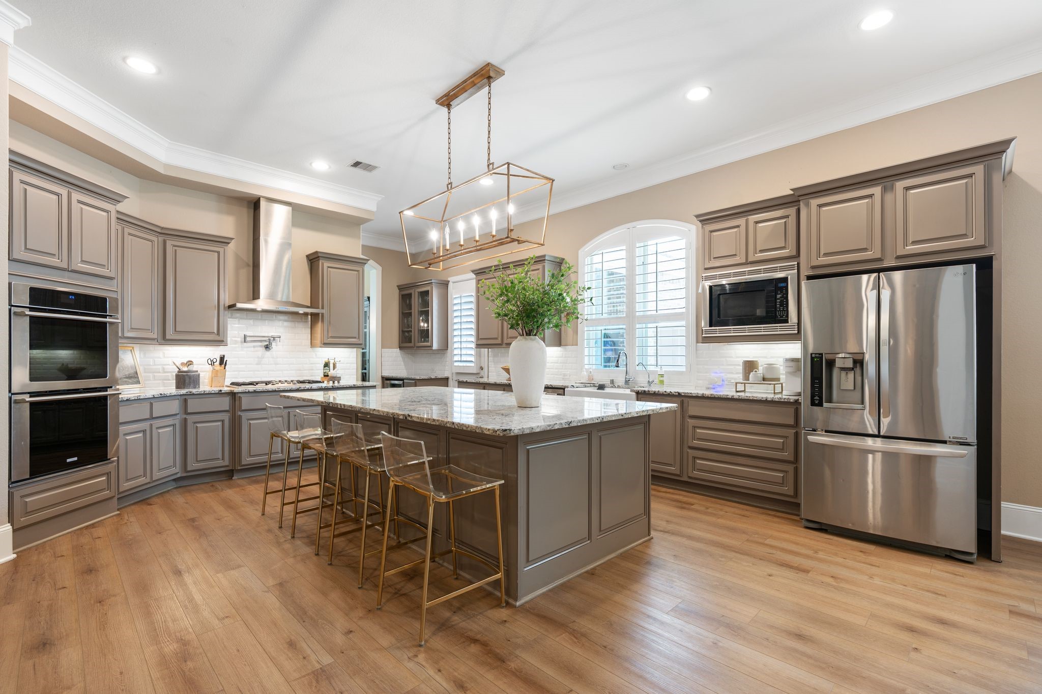 2914 Rutherford Pl Court Katy, TX 77494 - Photo 1 of 50 a kitchen with stainless steel appliances granite countertop a refrigerator a stove a sink dishwasher a oven with white cabinets and wooden floor