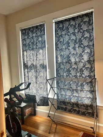 a bedroom with a bed and a flat tv screen on dresser