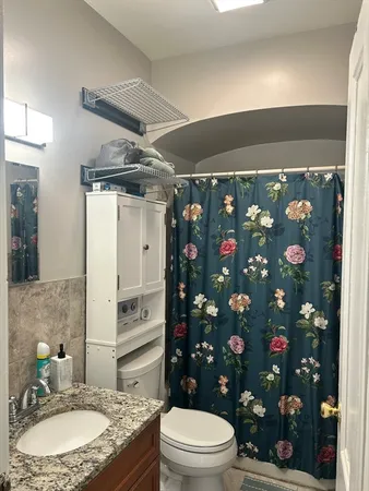 a bathroom with sink toilet and mirror