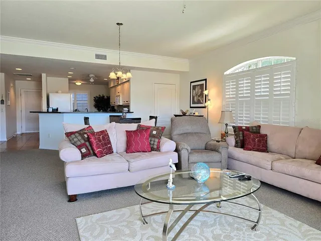 a living room with furniture and kitchen view
