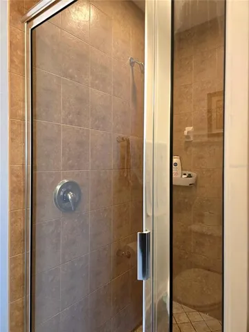 a bathroom with a glass shower door