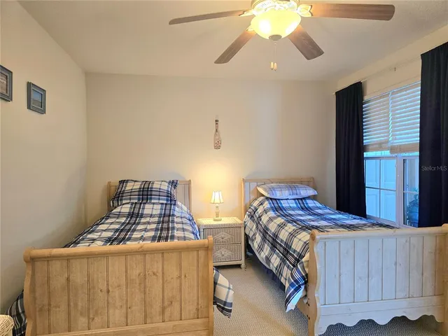 a bedroom with two beds and a chandelier