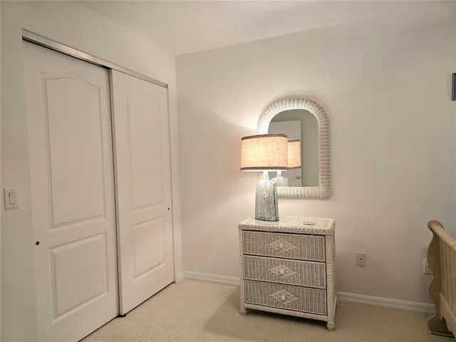 a room with a mirror and a dresser