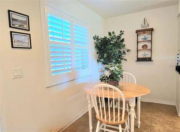 a view of a dining room with furniture and a potted plant