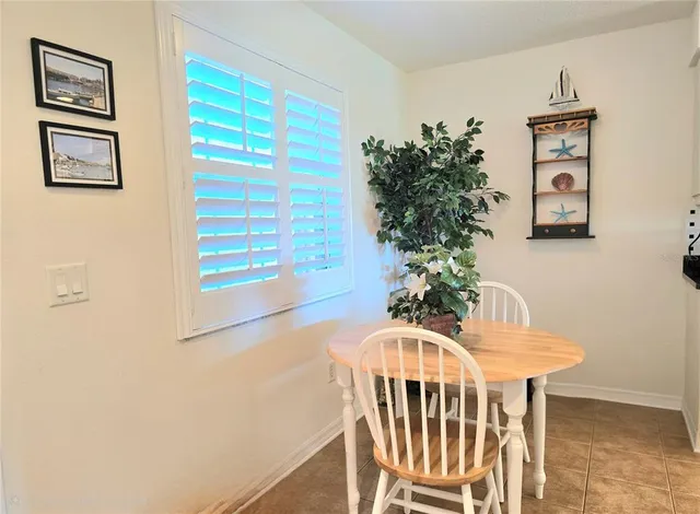 a view of a dining room with furniture and a potted plant