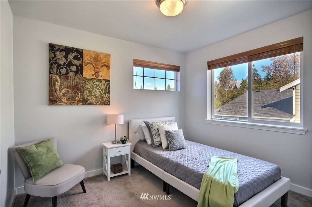 5217 Northeast 11th Street Renton, WA 98059 - Photo 17 of 25 a bedroom with a bed and window
