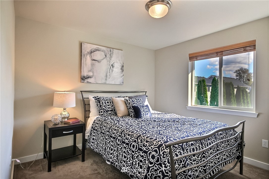 5217 Northeast 11th Street Renton, WA 98059 - Photo 18 of 25 a bedroom with a bed and a window
