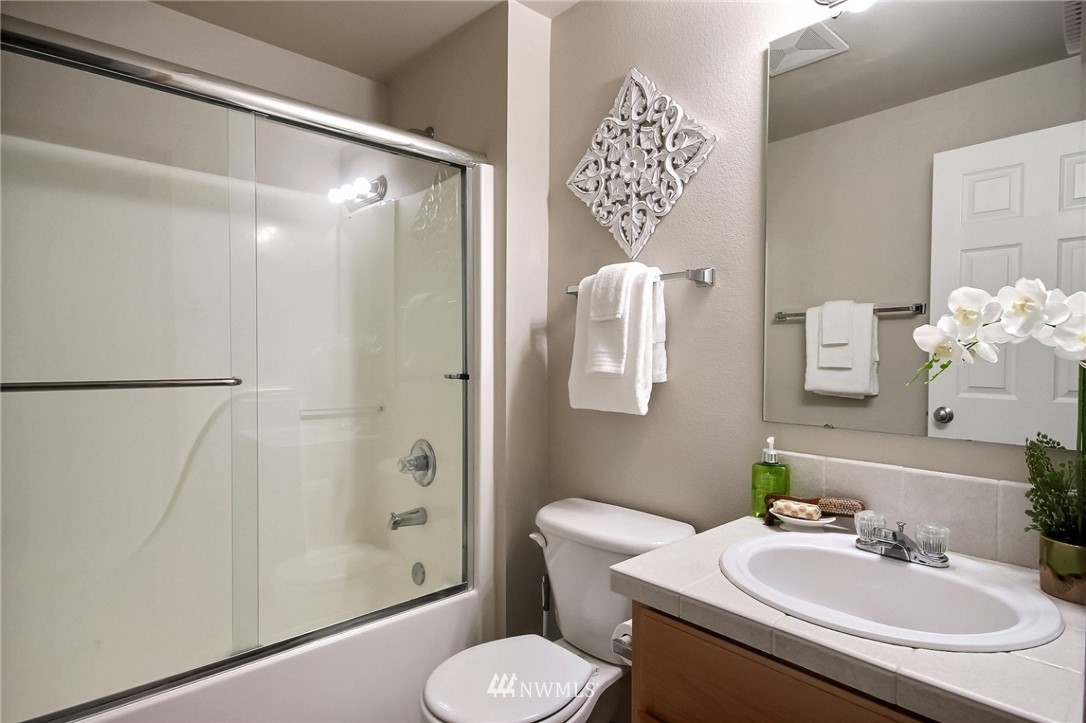 5217 Northeast 11th Street Renton, WA 98059 - Photo 21 of 25 a bathroom with a sink toilet and shower