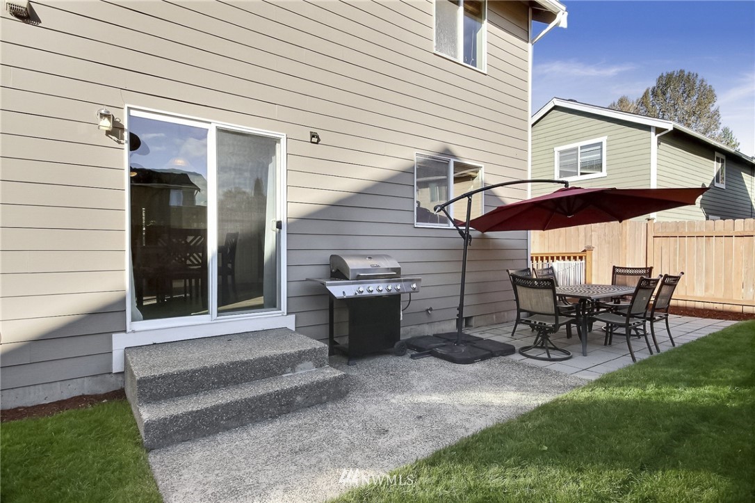 5217 Northeast 11th Street Renton, WA 98059 - Photo 23 of 25 a view of a patio with table and chairs with wooden fence