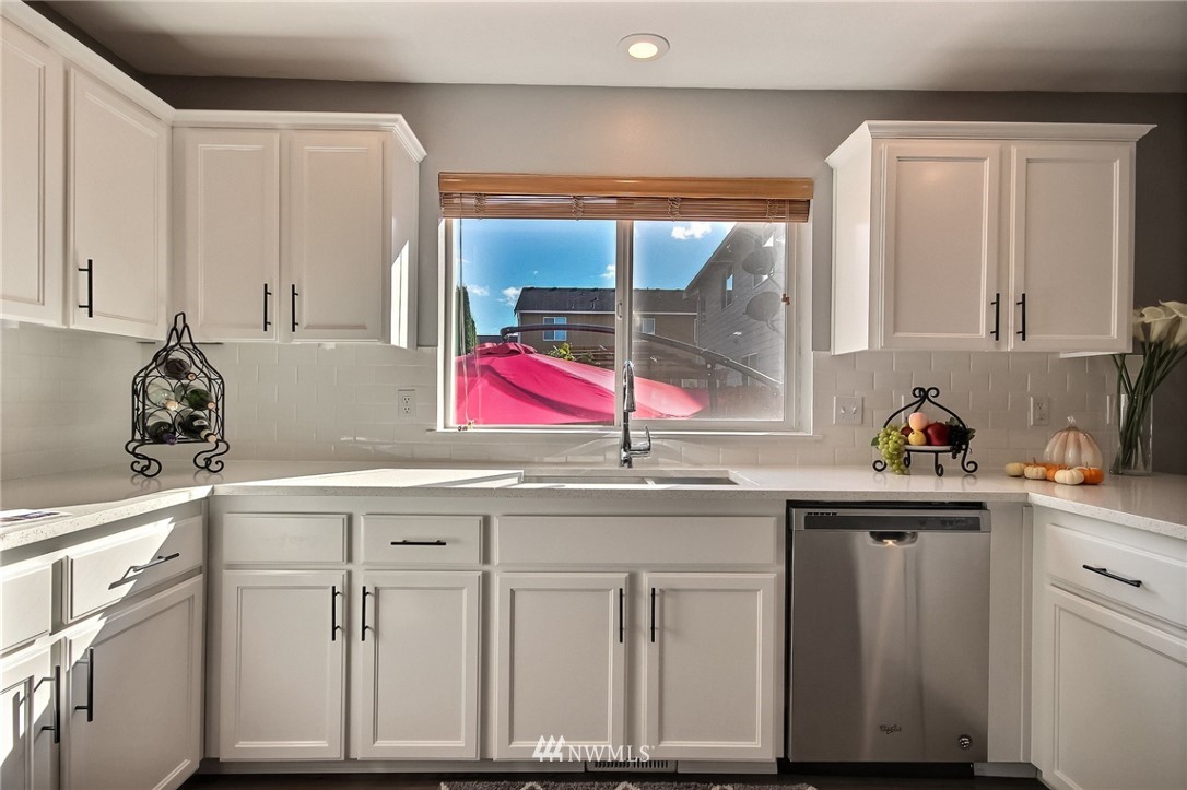 5217 Northeast 11th Street Renton, WA 98059 - Photo 5 of 25 a kitchen with white cabinets and sink