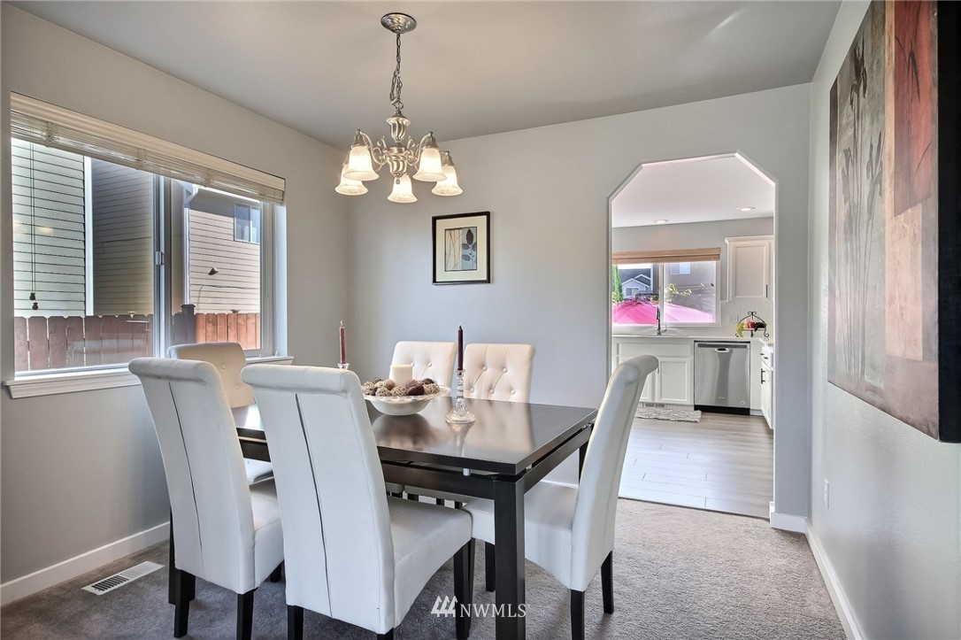 5217 Northeast 11th Street Renton, WA 98059 - Photo 10 of 25 a view of a dining room with furniture and a chandelier