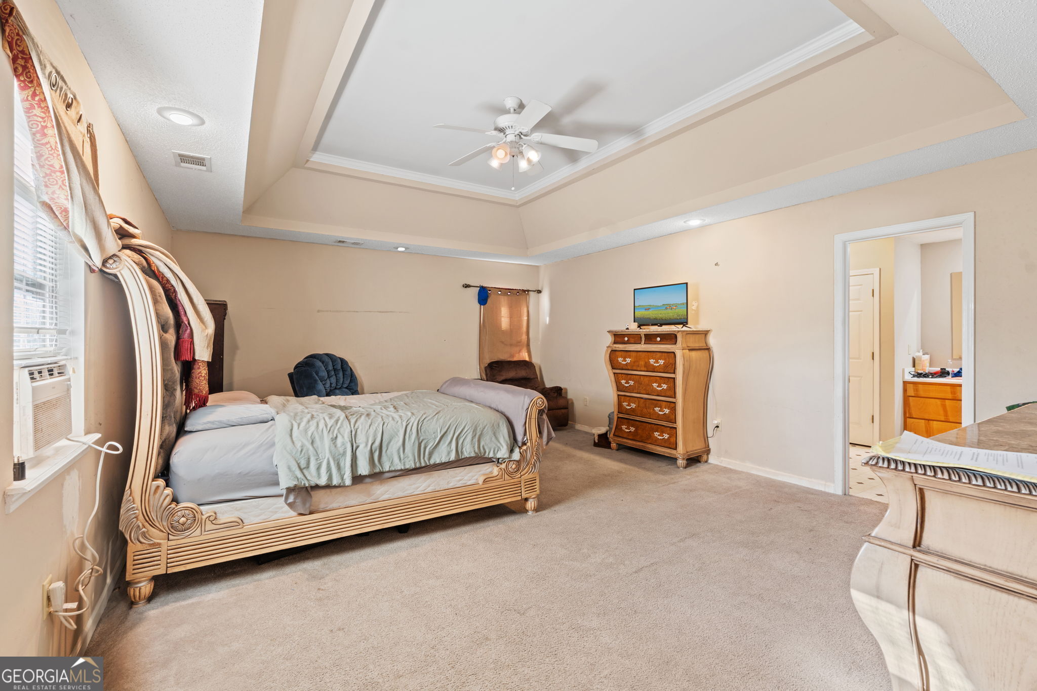 1525 Taylors Mill Road Fort Valley, GA 31030 - Photo 15 of 26 a bedroom with a bed and a chandelier