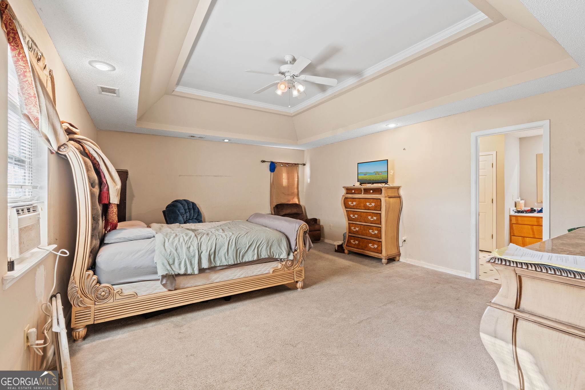 1525 Taylors Mill Road Fort Valley, GA 31030 - Photo 16 of 26 a bedroom with a bed and a chandelier