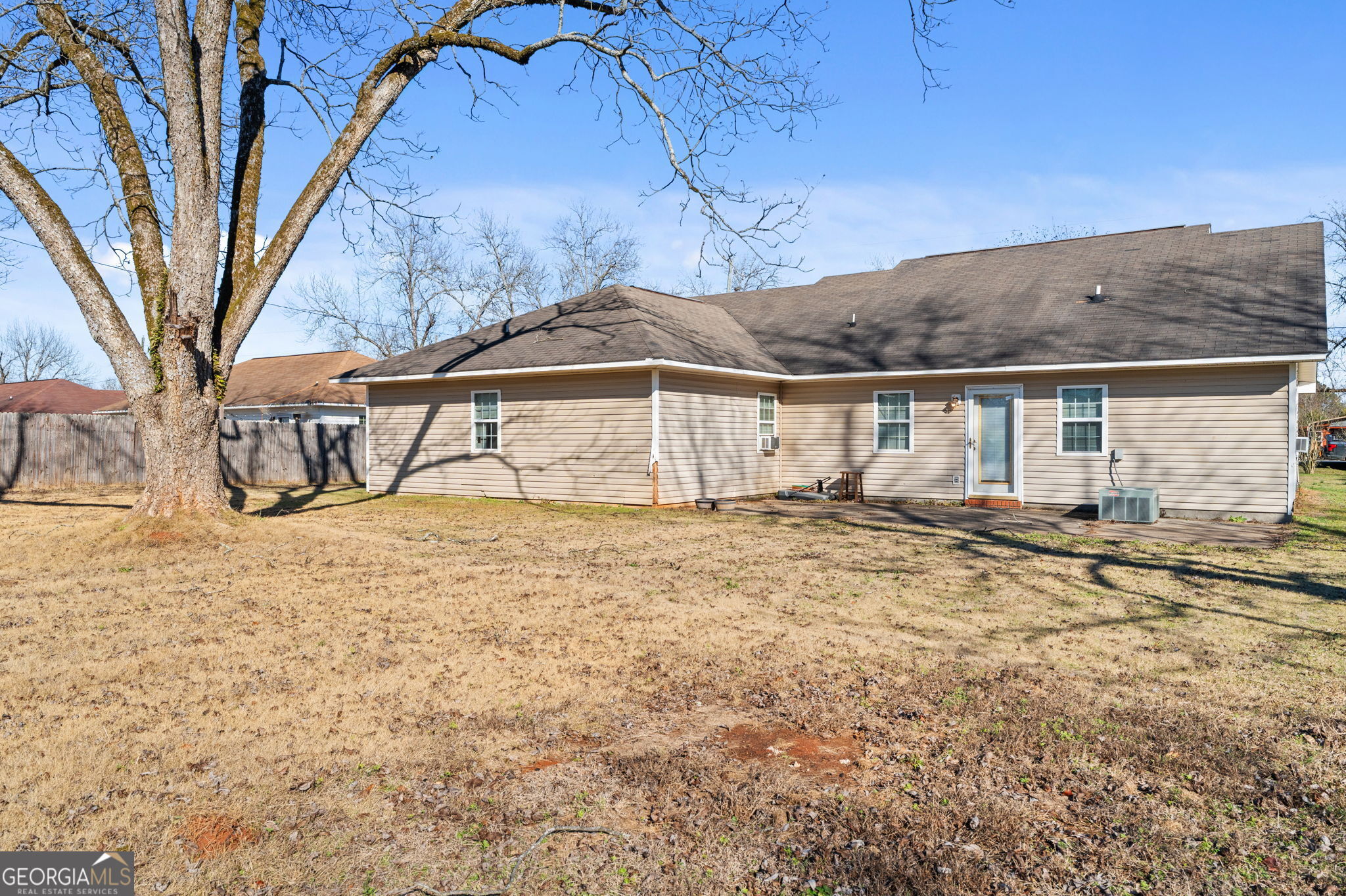 1525 Taylors Mill Road Fort Valley, GA 31030 - Photo 24 of 26 a white house with a large tree next to a yard