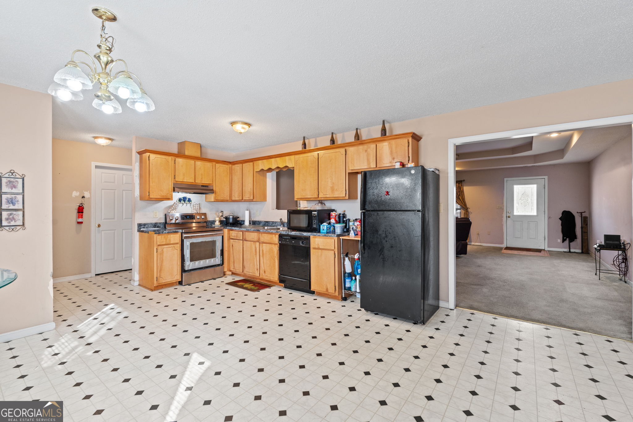 1525 Taylors Mill Road Fort Valley, GA 31030 - Photo 8 of 26 a kitchen with stainless steel appliances kitchen island granite countertop a refrigerator a sink a stove a oven a dining table and chairs