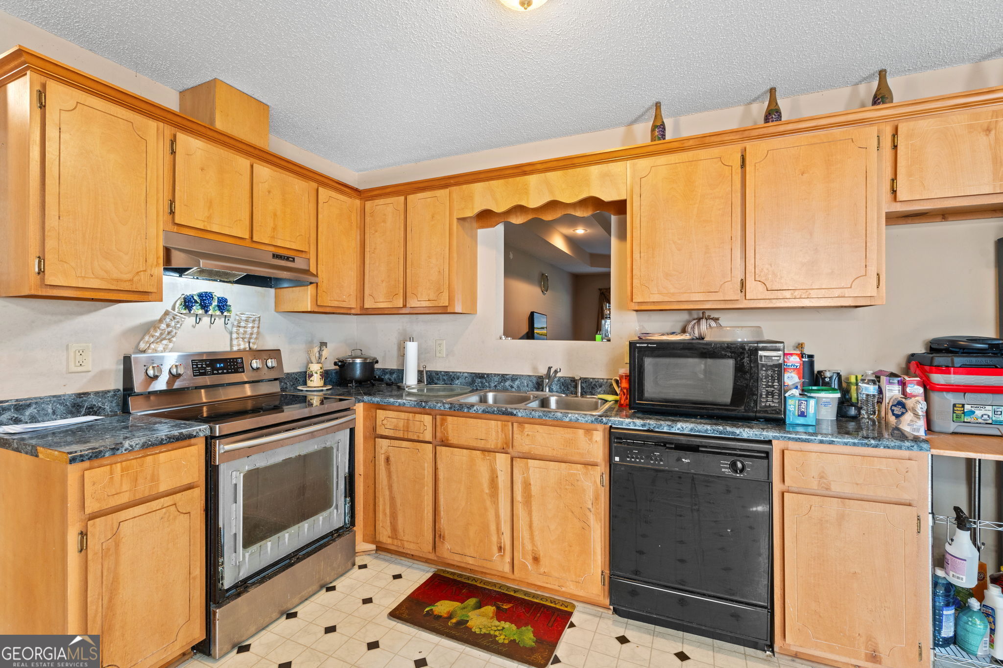 1525 Taylors Mill Road Fort Valley, GA 31030 - Photo 10 of 26 a kitchen with granite countertop a sink stainless steel appliances and cabinets