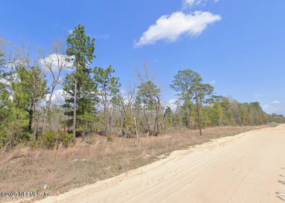 a view of a house with a yard and mountain