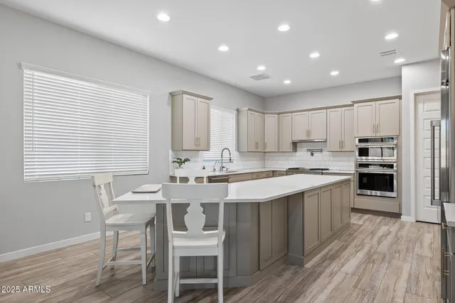 a kitchen with stainless steel appliances granite countertop a sink and stove