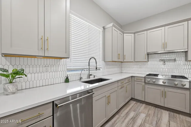 a kitchen with a sink stove and cabinets