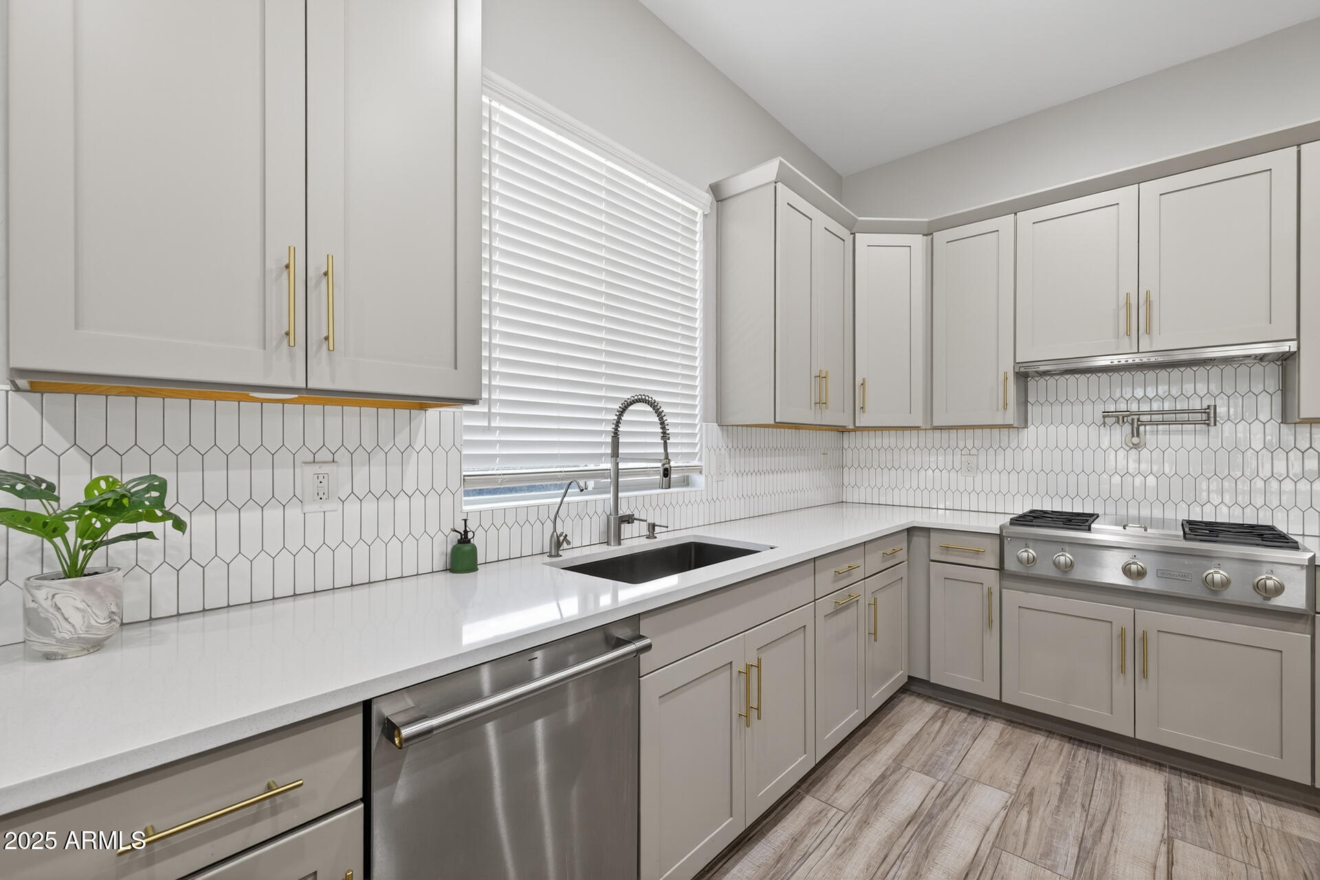 20194 East Raven Drive Queen Creek, AZ 85142 - Photo 13 of 39 a kitchen with a sink stove and cabinets
