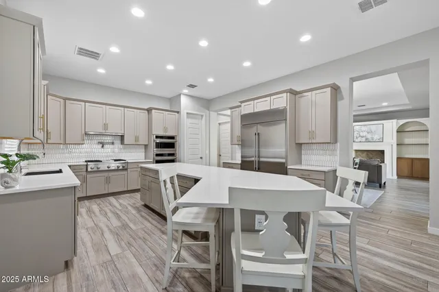 a kitchen with kitchen island wooden cabinets and stainless steel appliances