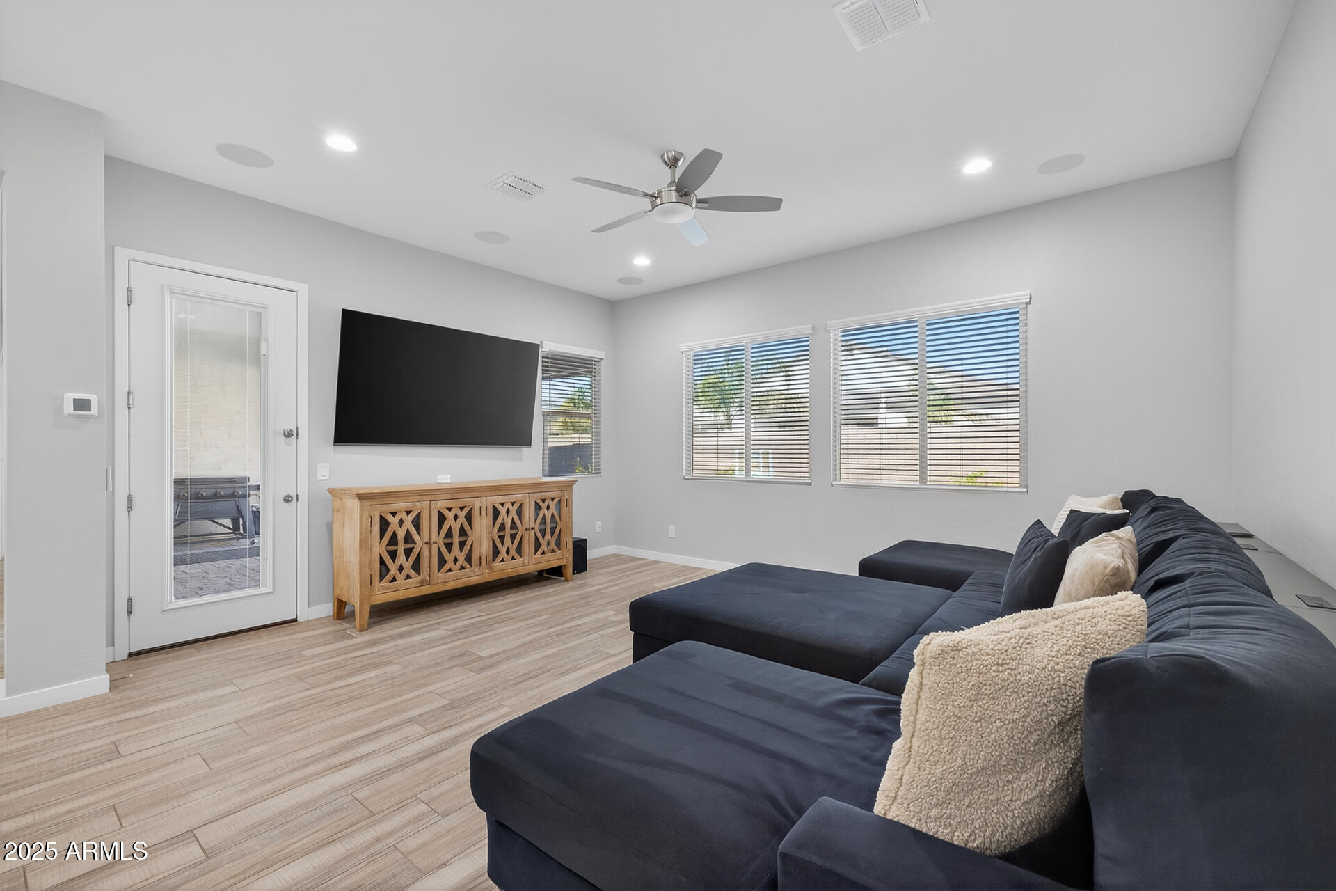 20194 East Raven Drive Queen Creek, AZ 85142 - Photo 16 of 39 a living room with furniture and a flat screen tv