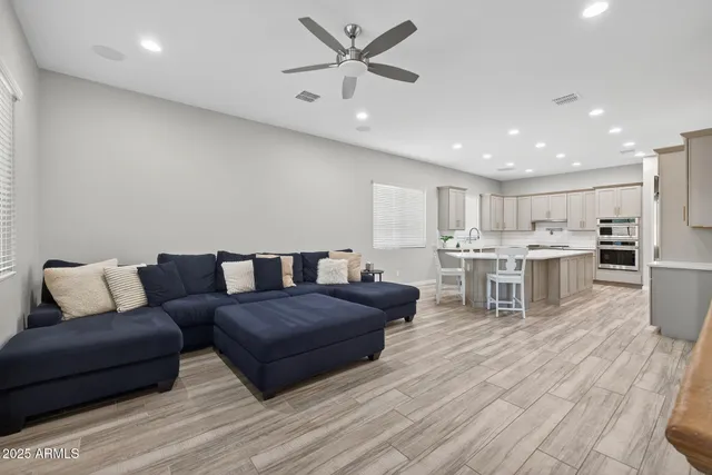 a living room with furniture and kitchen view