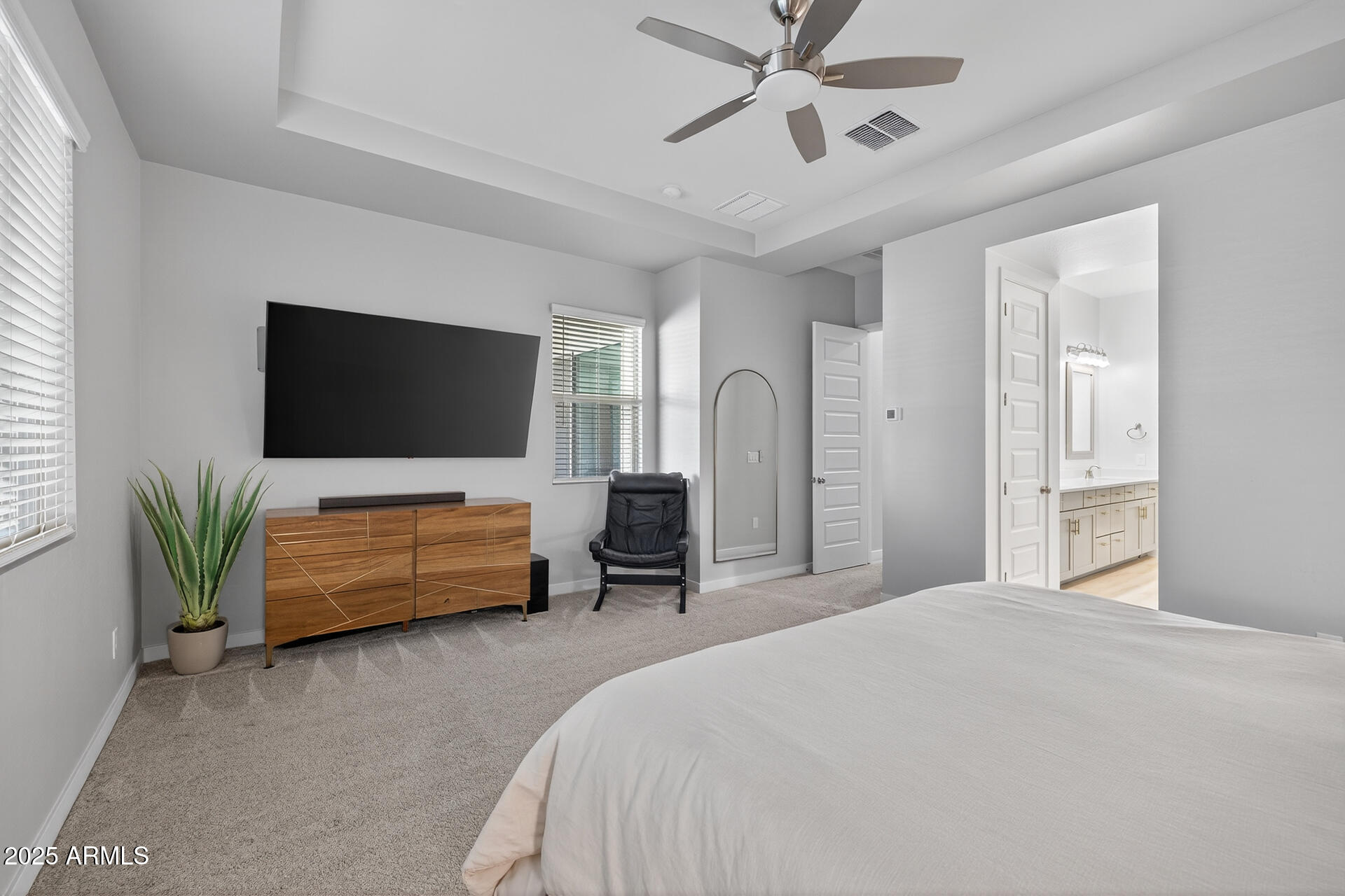 20194 East Raven Drive Queen Creek, AZ 85142 - Photo 19 of 39 a bedroom with a bed a flat screen tv and a couch