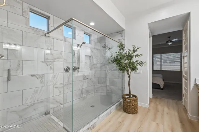 a bathroom with a bathtub and a potted plant