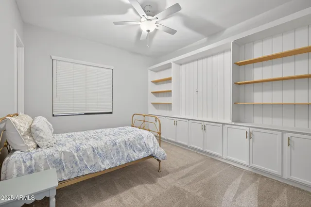 a bedroom with a bed and a book shelf