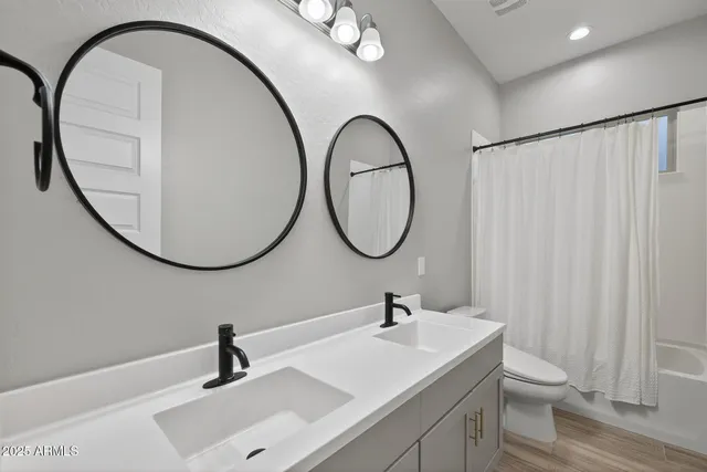 a bathroom with a sink a toilet and a mirror