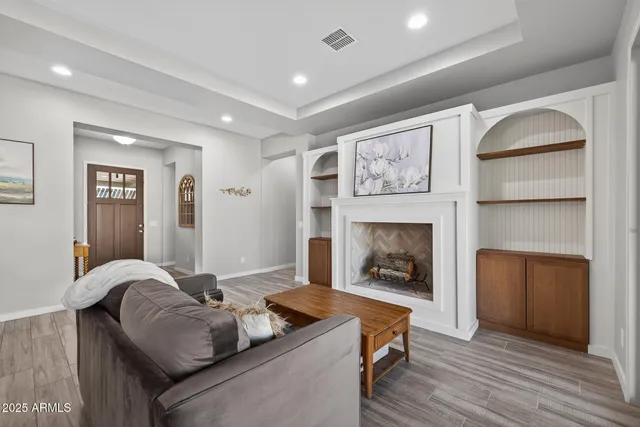 a living room with furniture and a fireplace