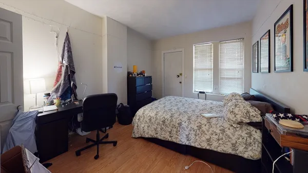 a bedroom with a bed and a window