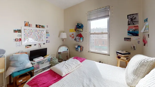 a bedroom with a bed and a window