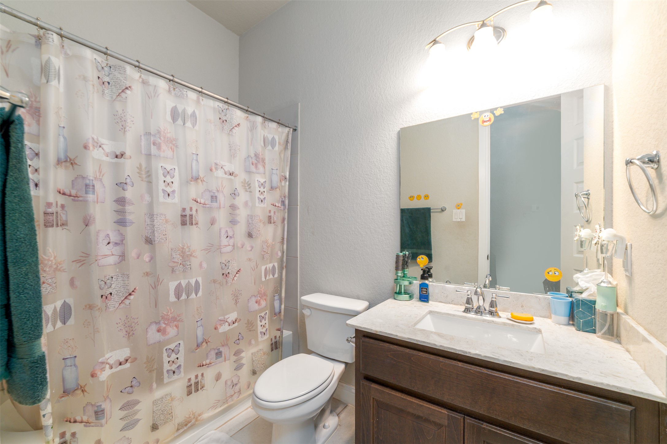 273 Rimrock Court Bastrop, TX 78602 - Photo 10 of 17 a bathroom with a sink a toilet and shower curtain