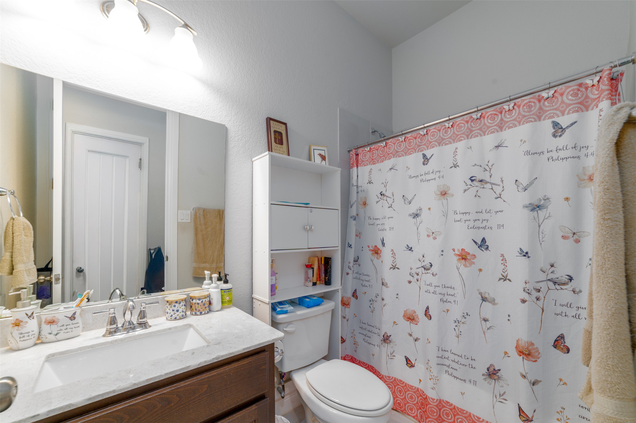 273 Rimrock Court Bastrop, TX 78602 - Photo 12 of 17 a bathroom with a sink a toilet and shower curtain