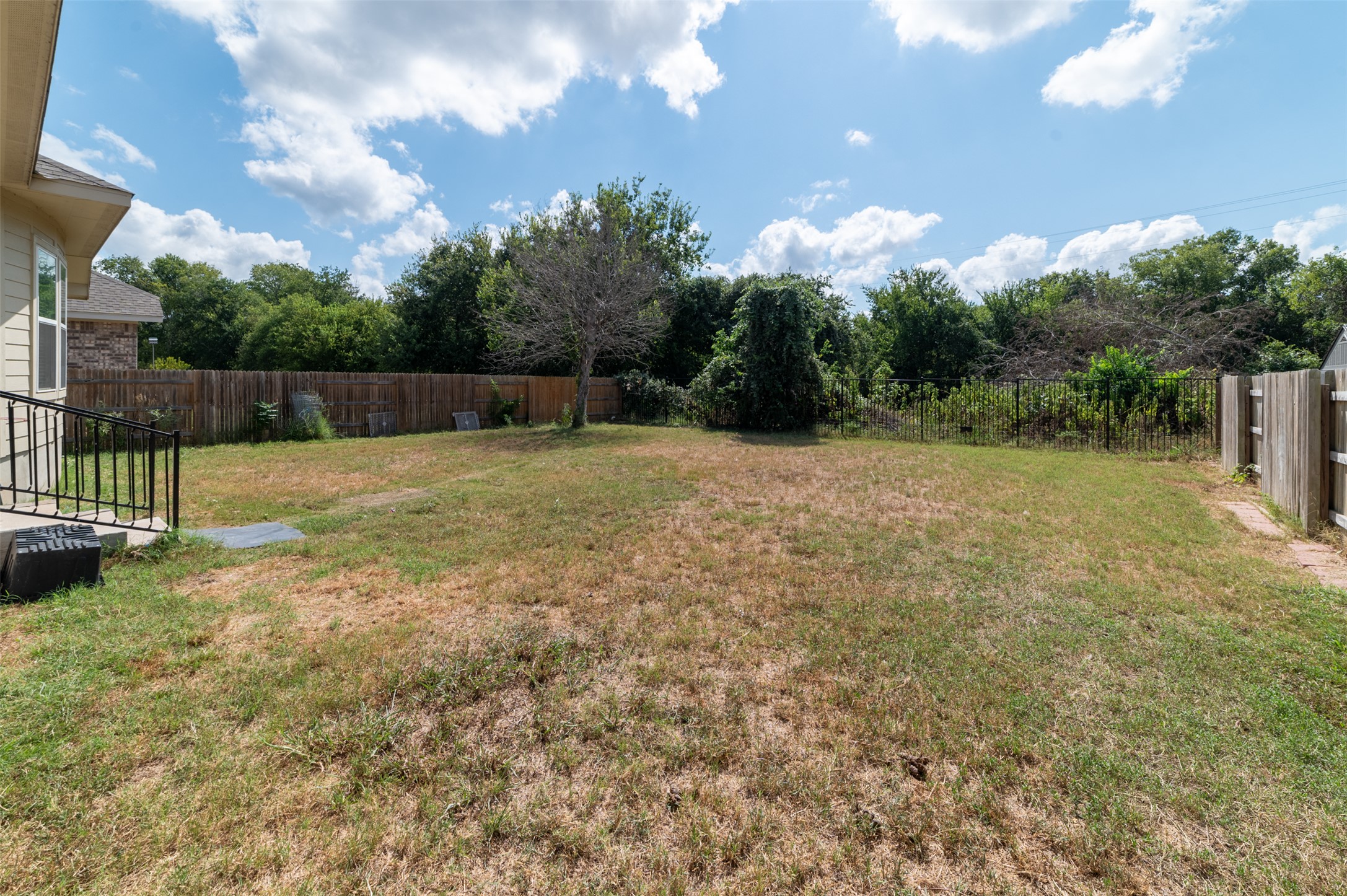 273 Rimrock Court Bastrop, TX 78602 - Photo 15 of 17 a backyard of a house with table and chairs
