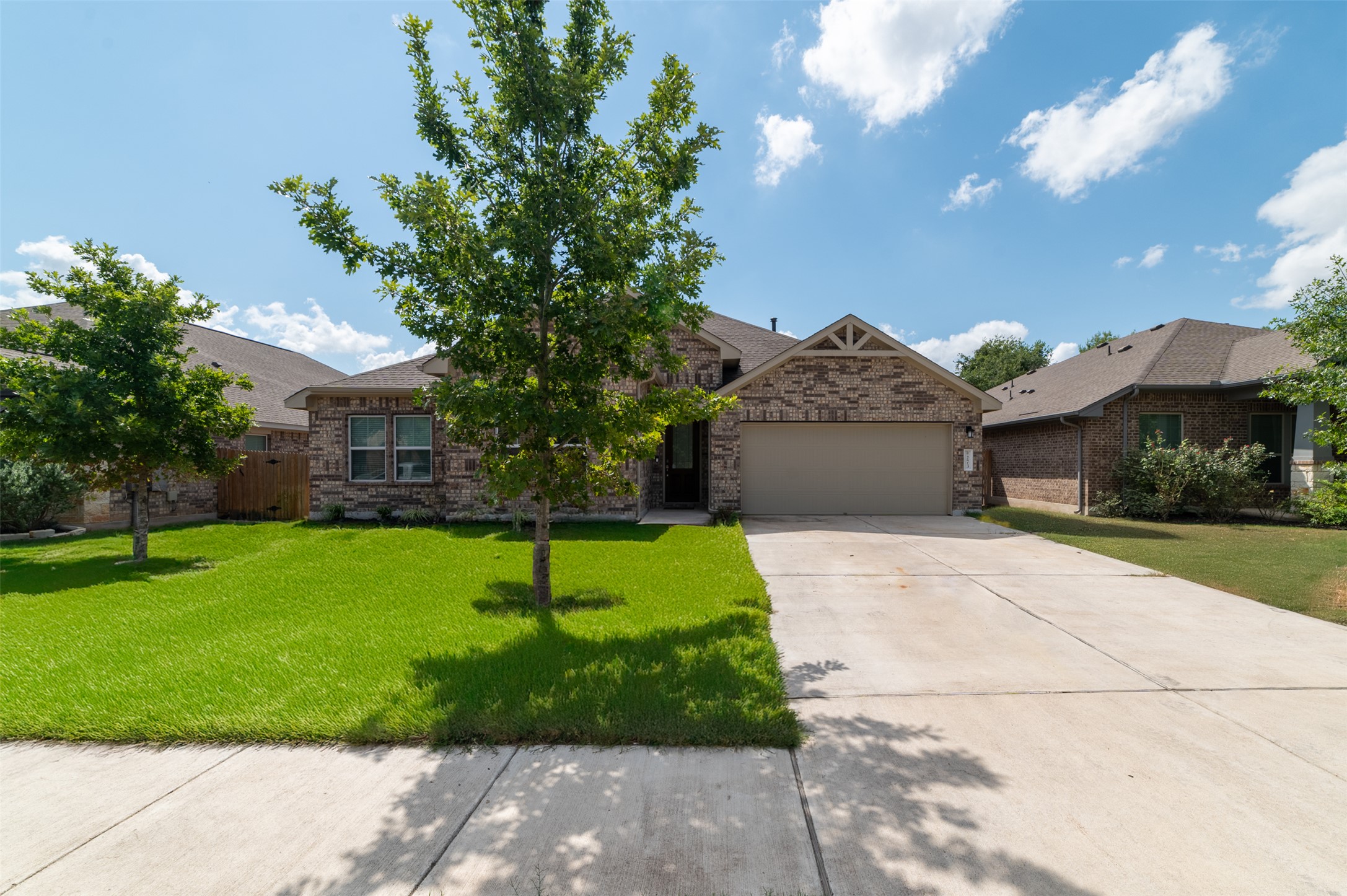 273 Rimrock Court Bastrop, TX 78602 - Photo 16 of 17 a front view of a house with a yard and garage