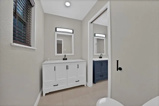 a bathroom with mirror a sink and vanity