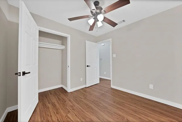 wooden floor in an empty room with a window