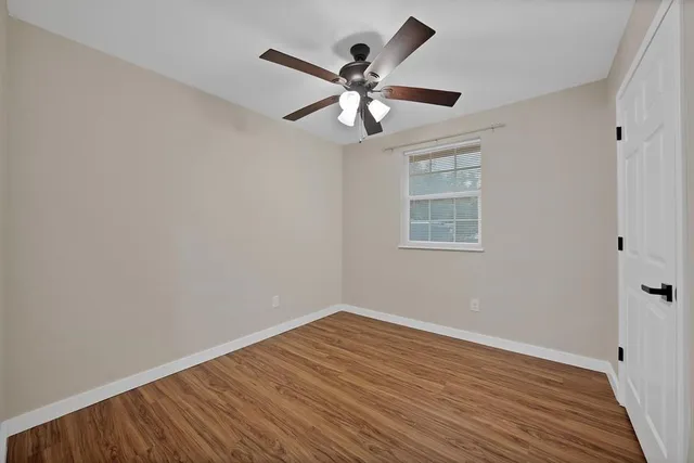 wooden floor in an empty room with a window
