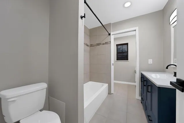 a bathroom with a toilet a sink and shower