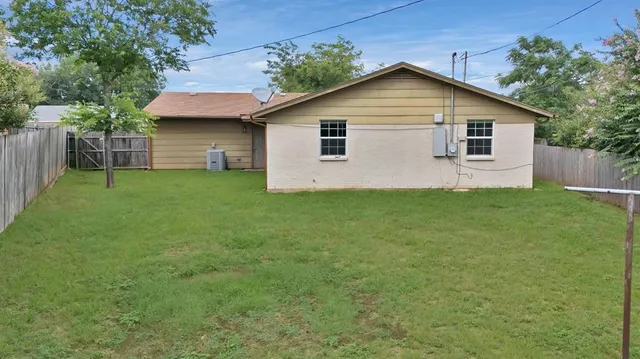 a front view of house with yard and trees