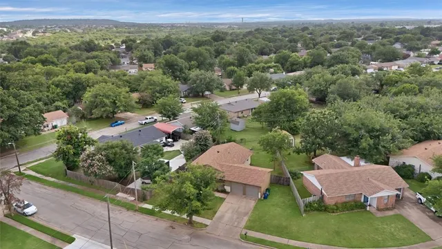 an aerial view of a house with a yard