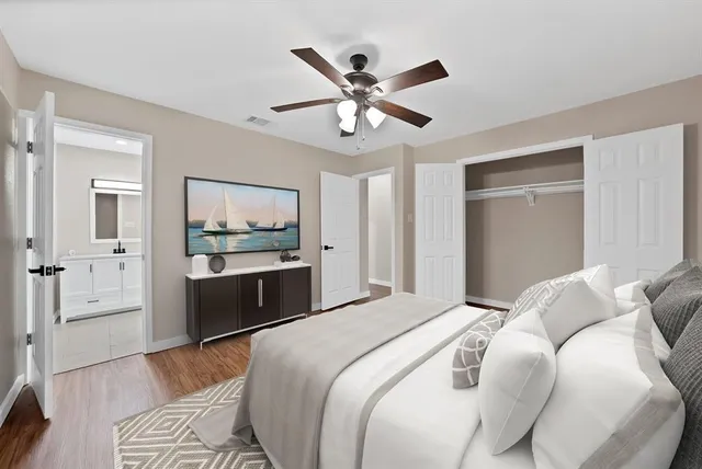 a bedroom with a large bed and a chandelier