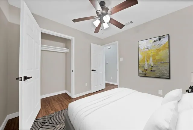 a bedroom with a bed and a chandelier