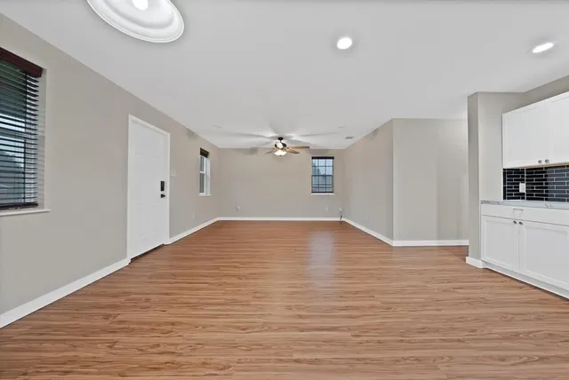 a view of empty room with wooden floor